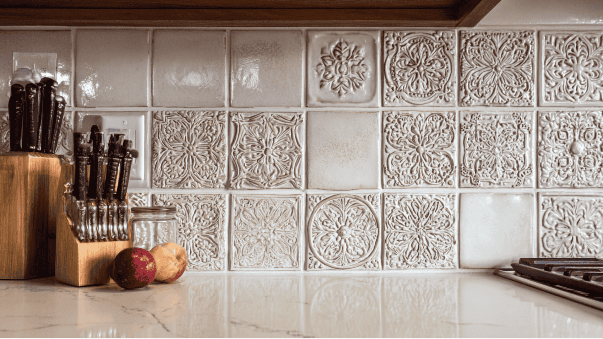 A kitchen counter featuring a knife resting beside a knife block filled with various knives.