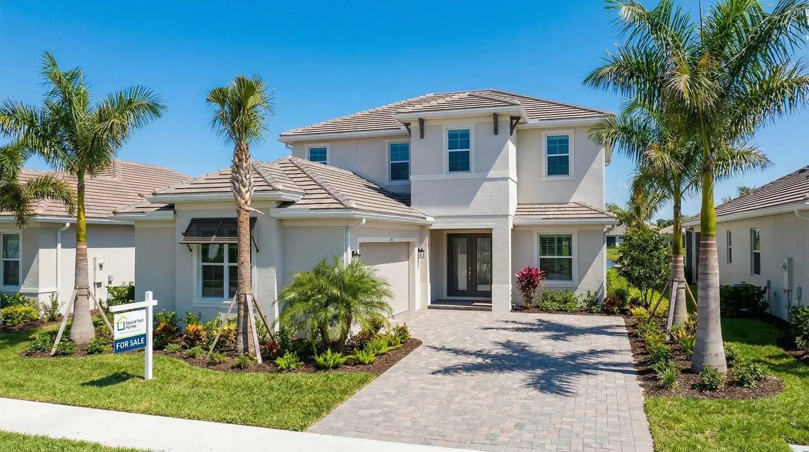 Modern two-story house with palm trees and for sale sign in sunny suburban neighborhood