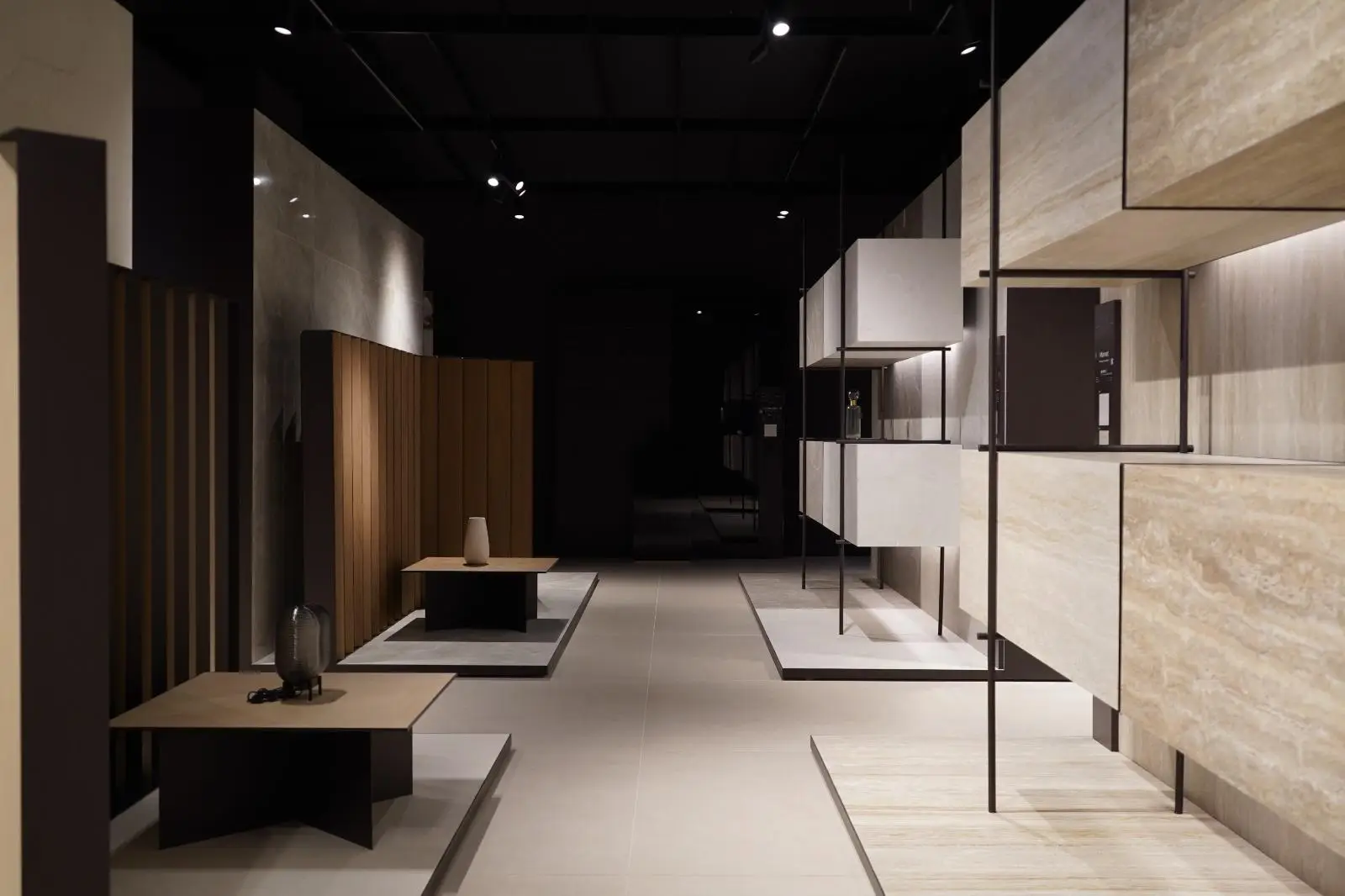 Modern showroom with wooden panels and minimalist tables under soft lighting