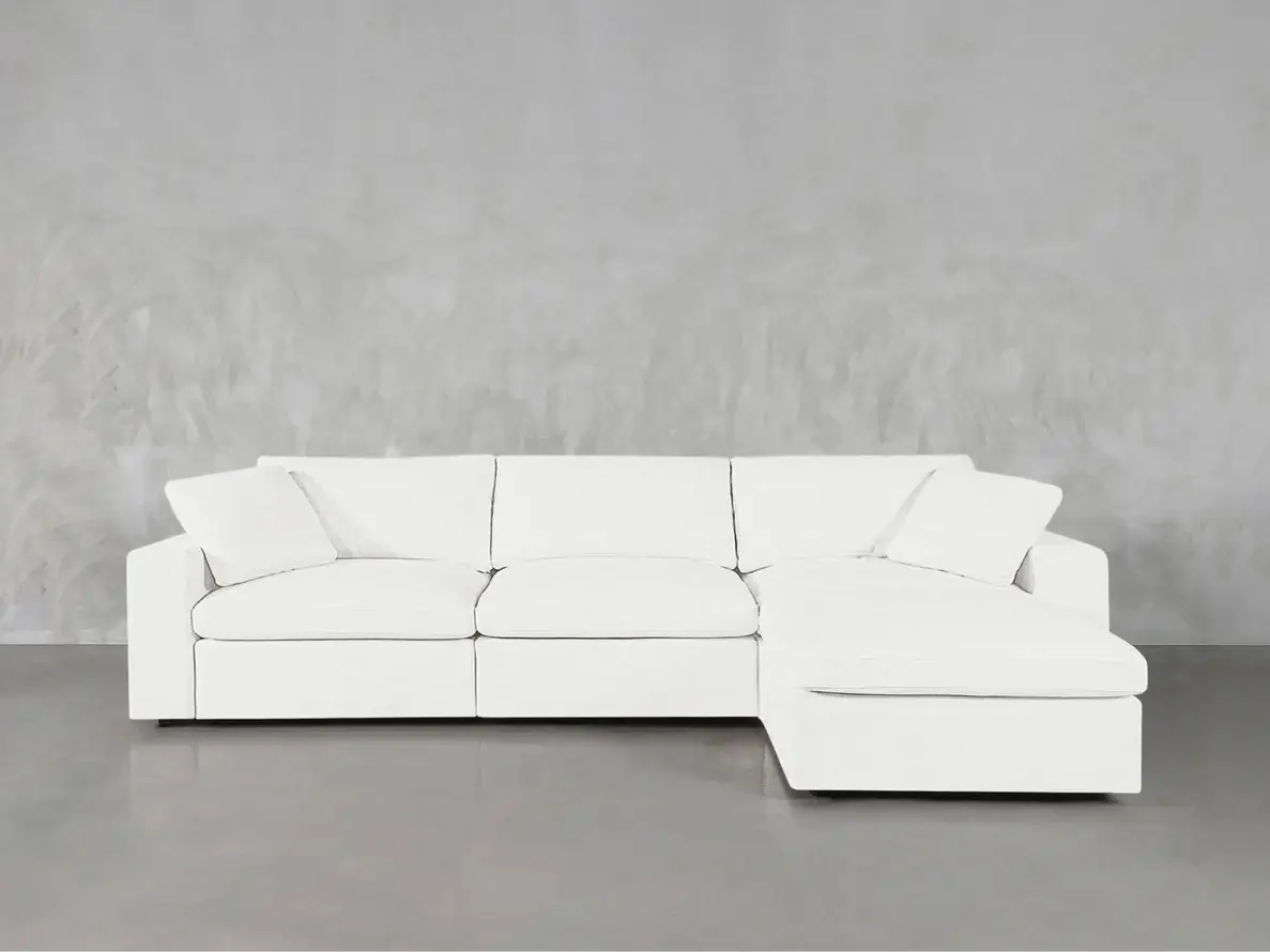 White sectional sofa on smooth concrete floor against gray textured wall