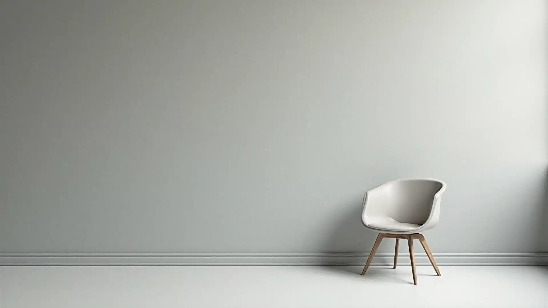 A solitary chair positioned in an empty room, illuminated by natural light streaming through a nearby window