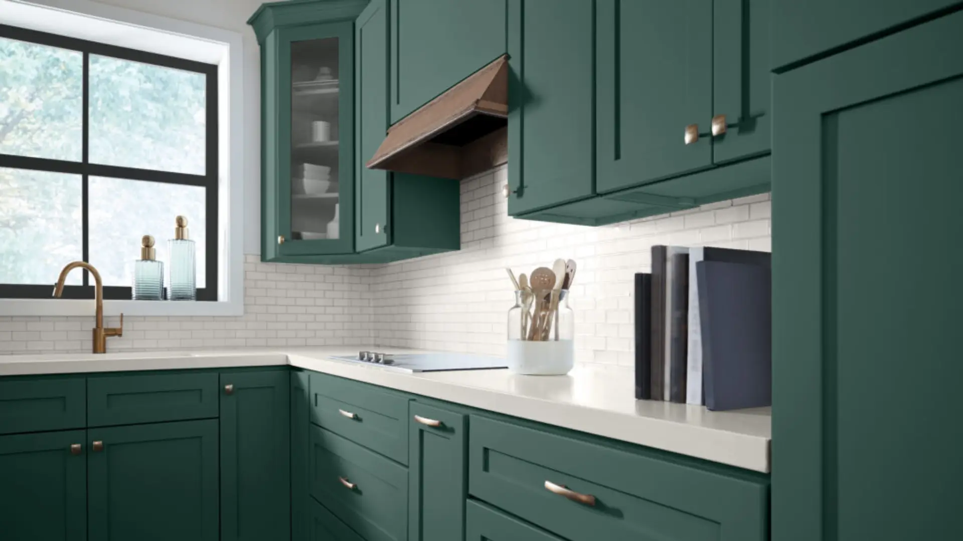 Kitchen corner featuring deep forest green shaker cabinets, white subway tile backsplash, white countertops, and a bronze faucet.