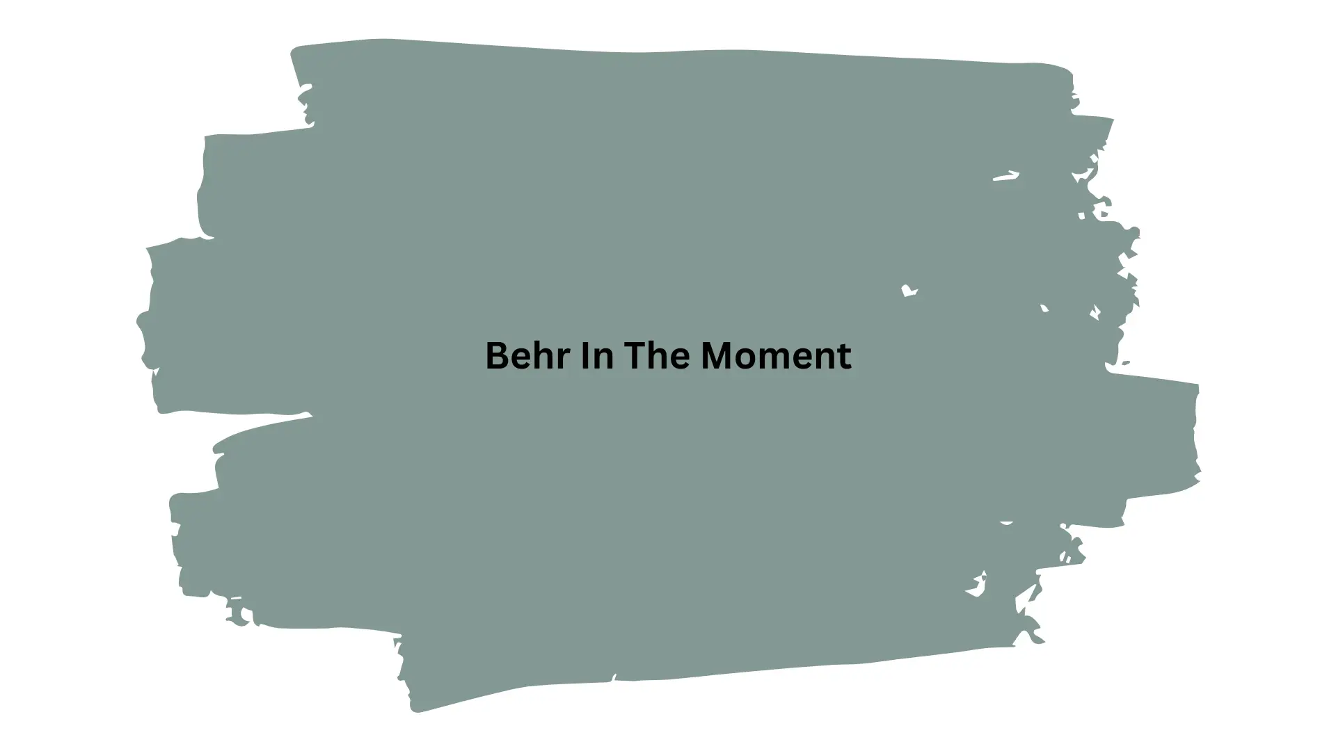 Swatch of Behr paint color "In The Moment," a muted sage green, displayed with rough, brushstroke edges against a white background.