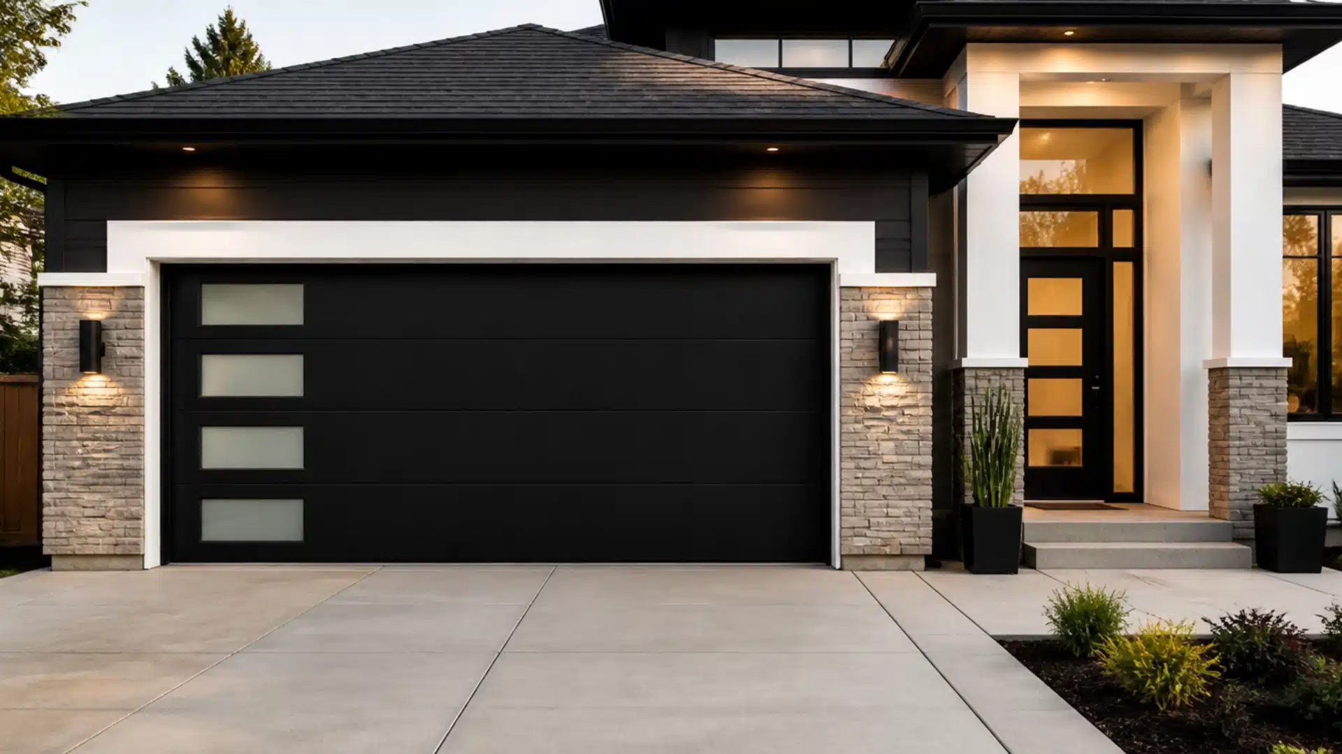 A contemporary house featuring a sleek black garage door, showcasing modern architectural design