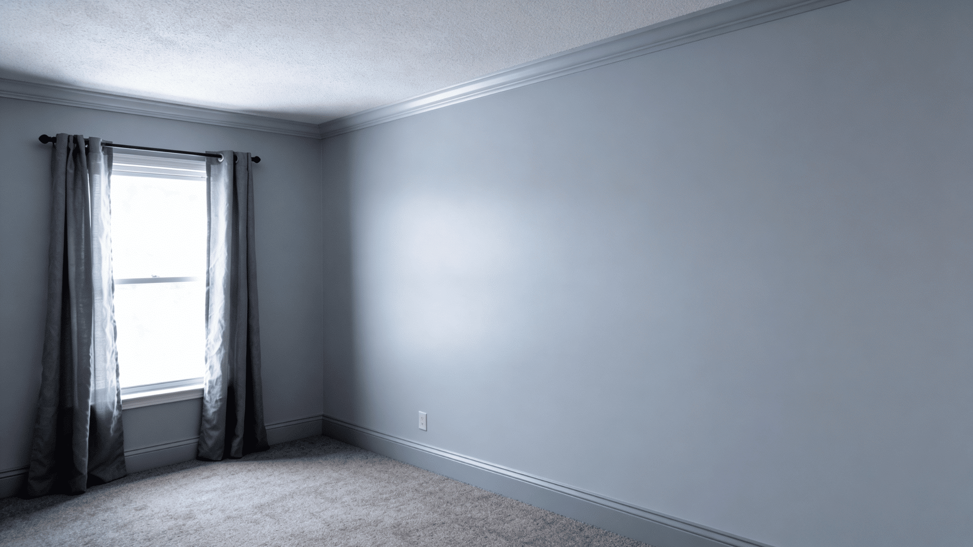 compact room with low ceilings and matching gray walls and trim making the space appear taller.