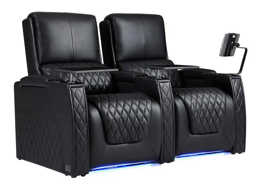 Black leather recliner chairs with diamond stitching and armrest-mounted tablet holder in modern setting