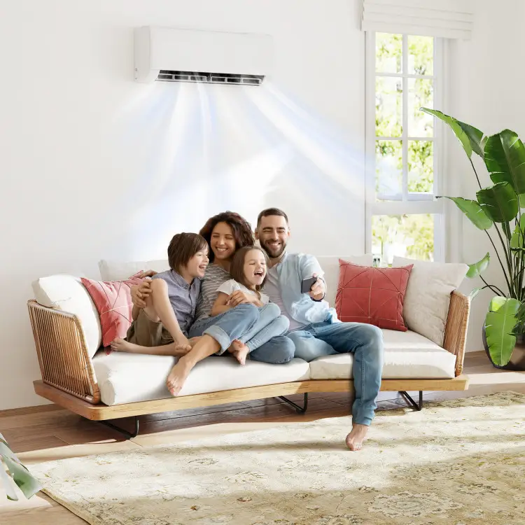 Family sitting on couch enjoying air conditioning in bright living room with large windows