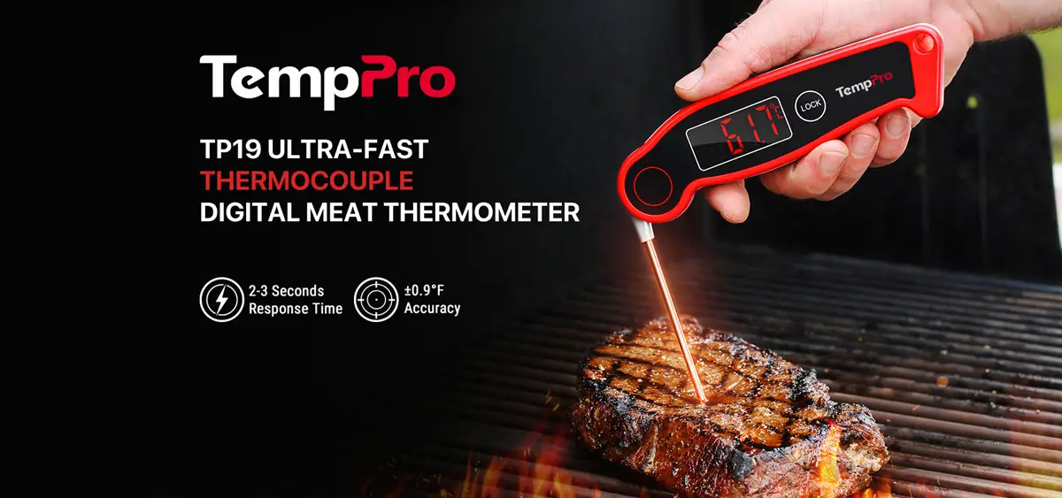 Digital meat thermometer measuring temperature of grilled steak in outdoor barbecue setting