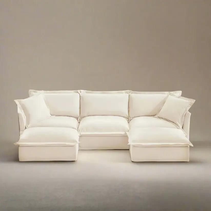 Beige sectional sofa with plush cushions in a minimalist setting