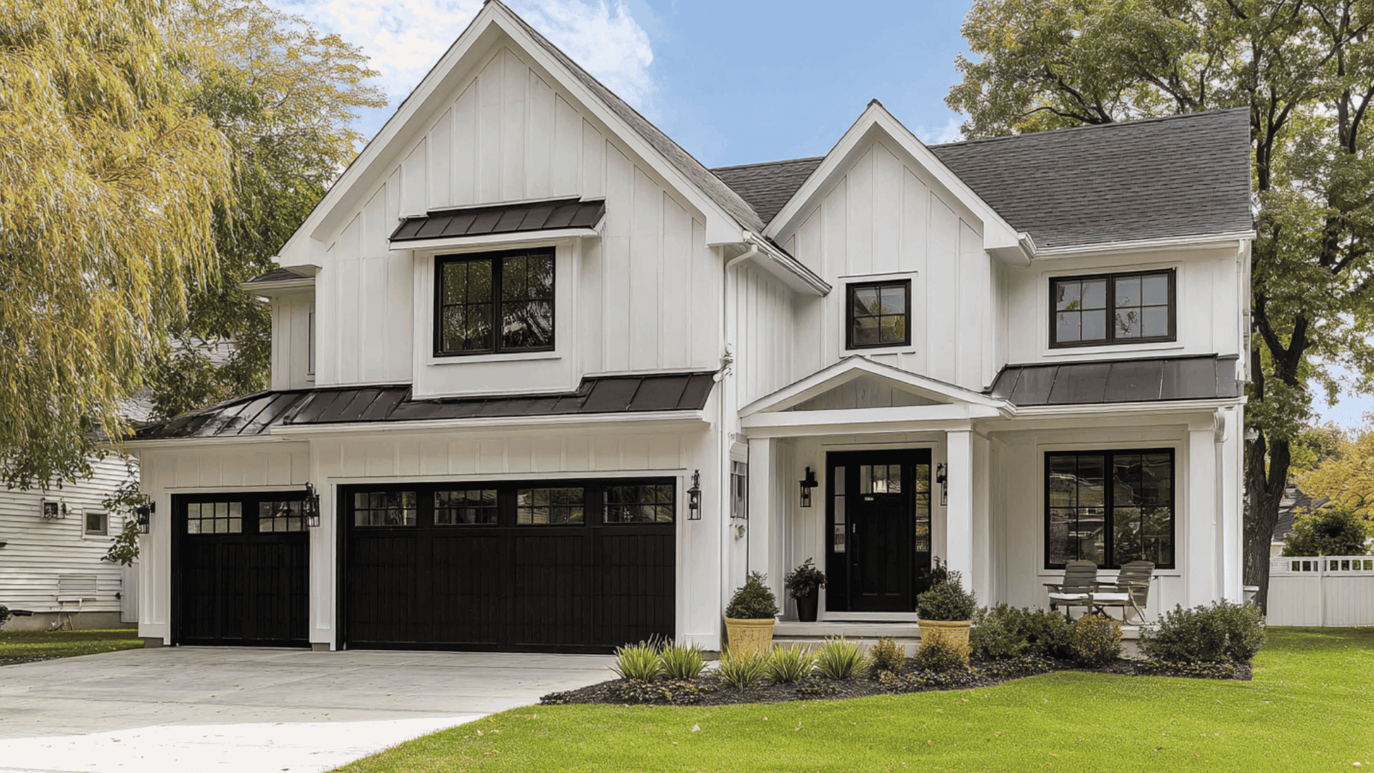 white siding house with black trim and black garage doors