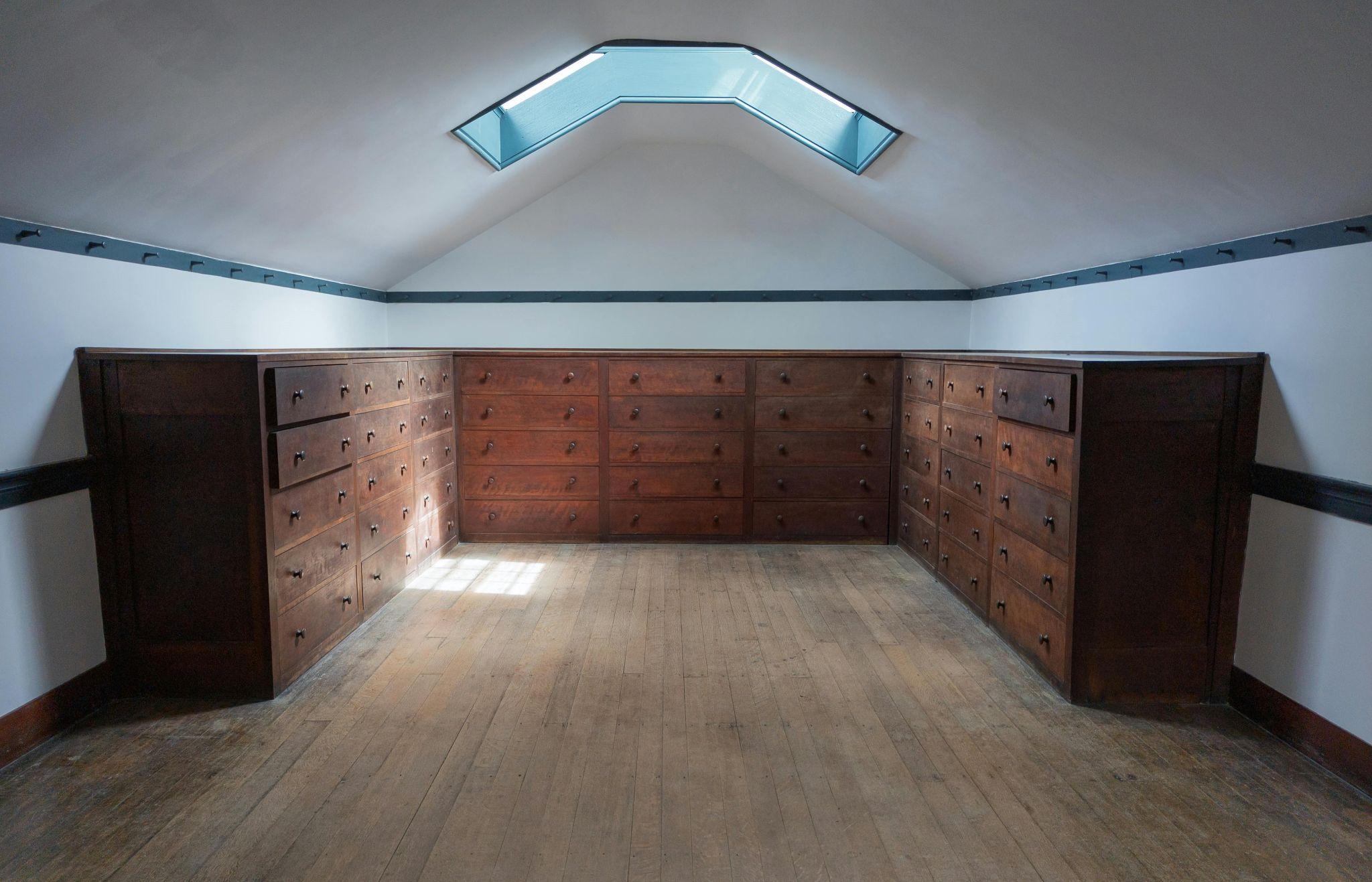 An attic room with storage cabinets.