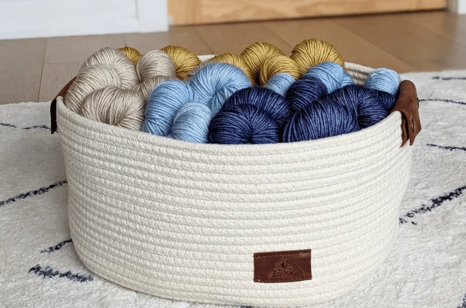 Colorful yarn skeins in a woven basket.