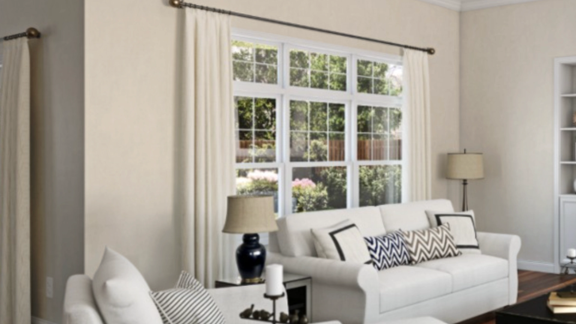 Cozy living room showcasing white furniture, a window, and greige walls for a warm ambiance.