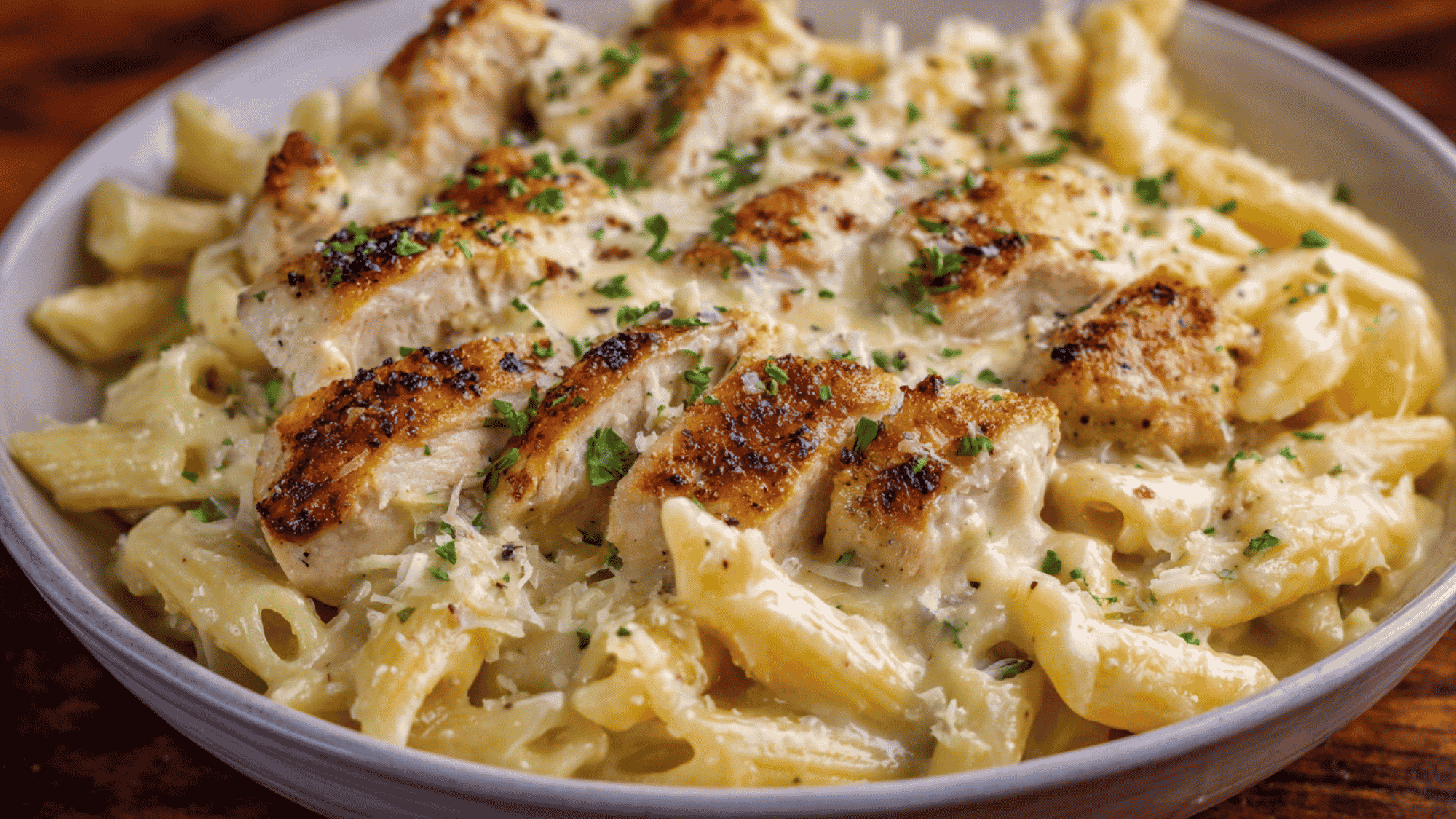 Delicious, warm chicken alfredo served in a shallow bowl.