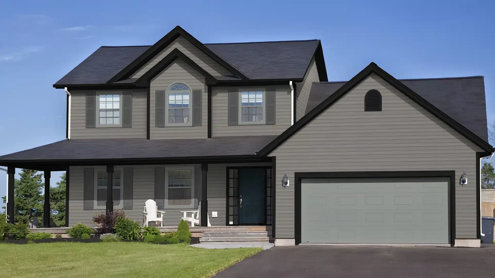 A two story gray house with a dark roof, porch, showcasing grey and white color scheme