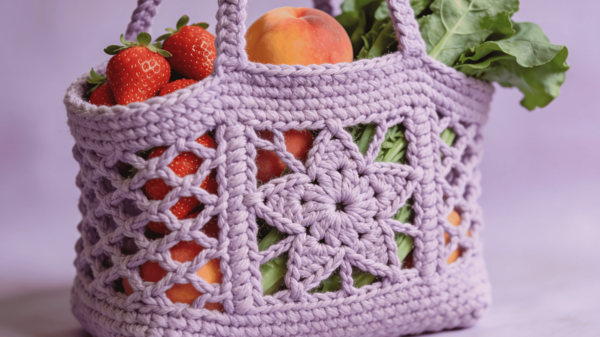 crochet market bag with a decorative star stitch front panel, filled with fresh produce