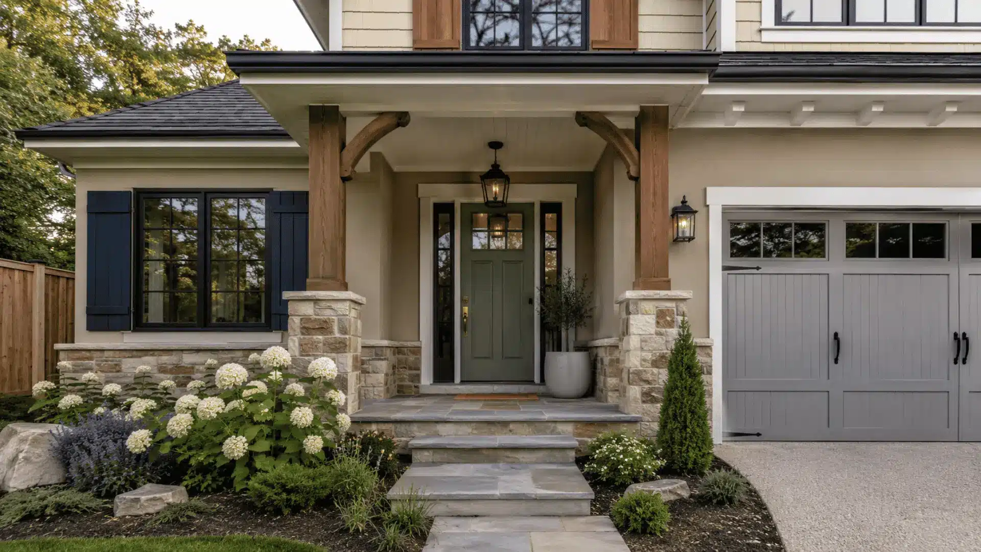Sage green home exterior with stone accents, navy shutters, and landscaped front yard.