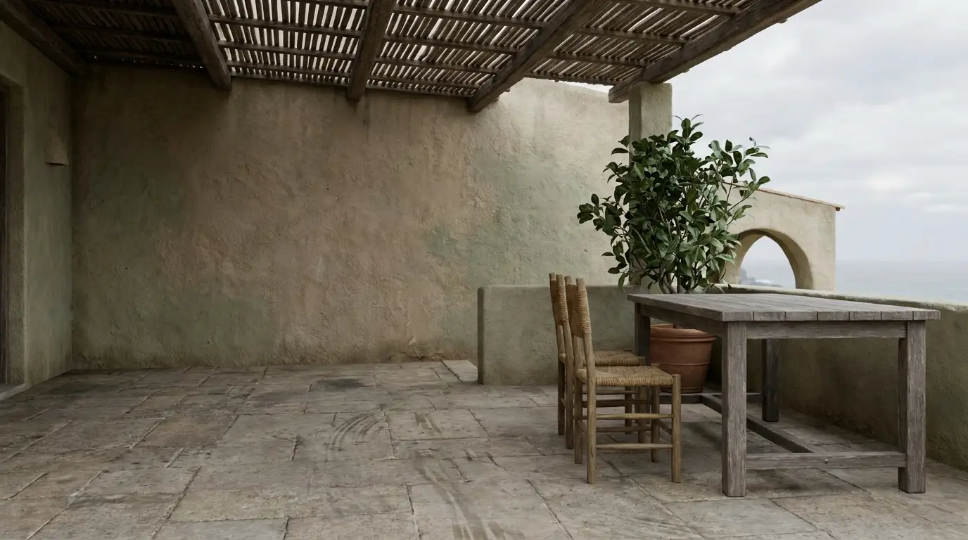 Outdoor terrace with wooden table and chairs, potted plant, stone floor, and lattice ceiling