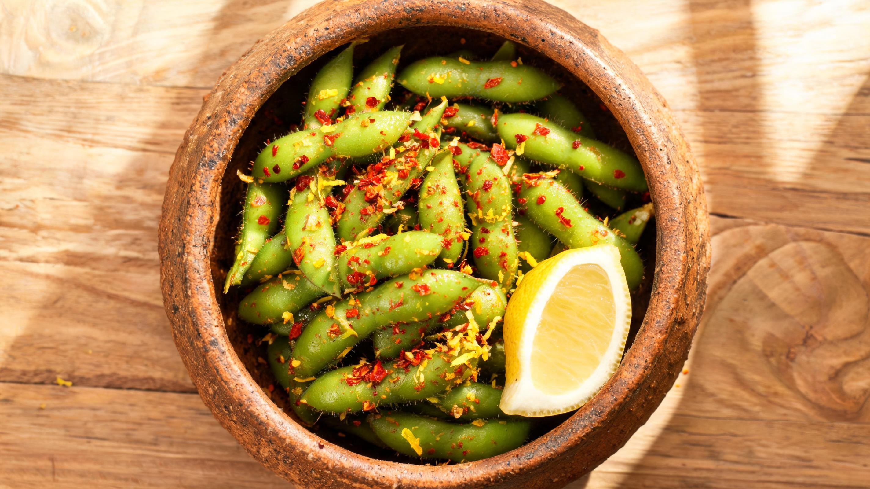 Steamed edamame pods tossed with coarse sea salt and red chili flakes.