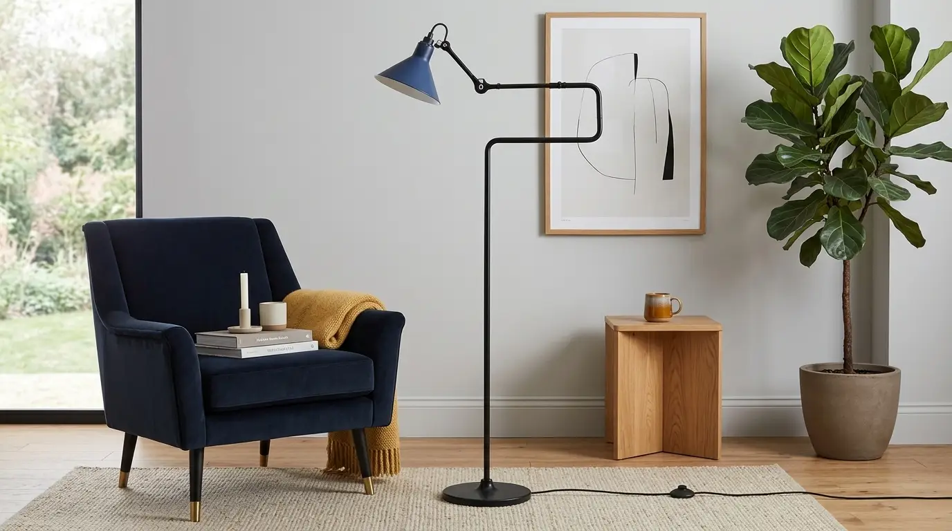 Navy armchair with yellow throw and floor lamp in modern living room with potted plant