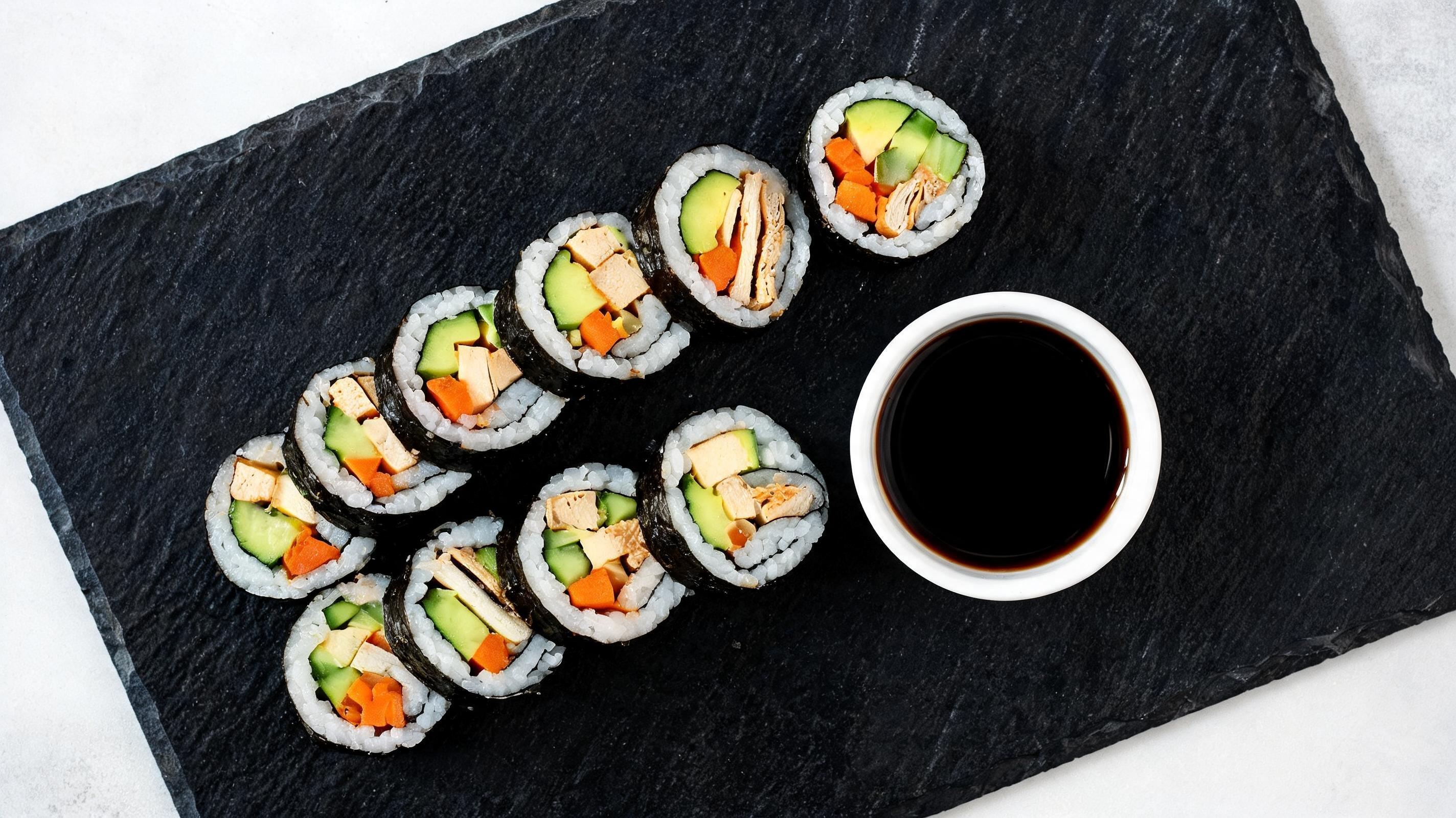 Slices of homemade vegan sushi rolls filled with avocado and cucumber.
