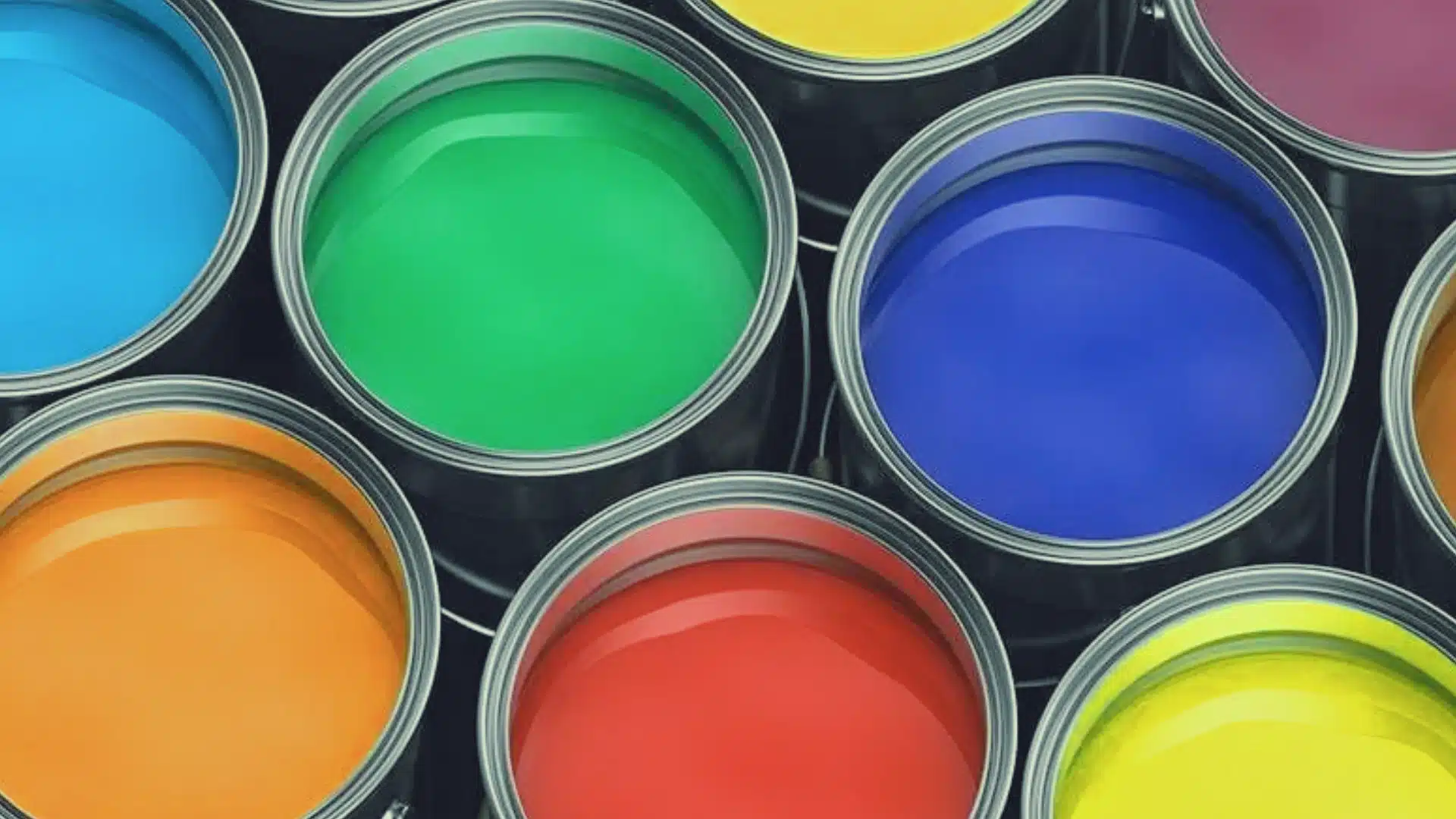 Open cans of water-based paint in blue, green, red, yellow, and orange