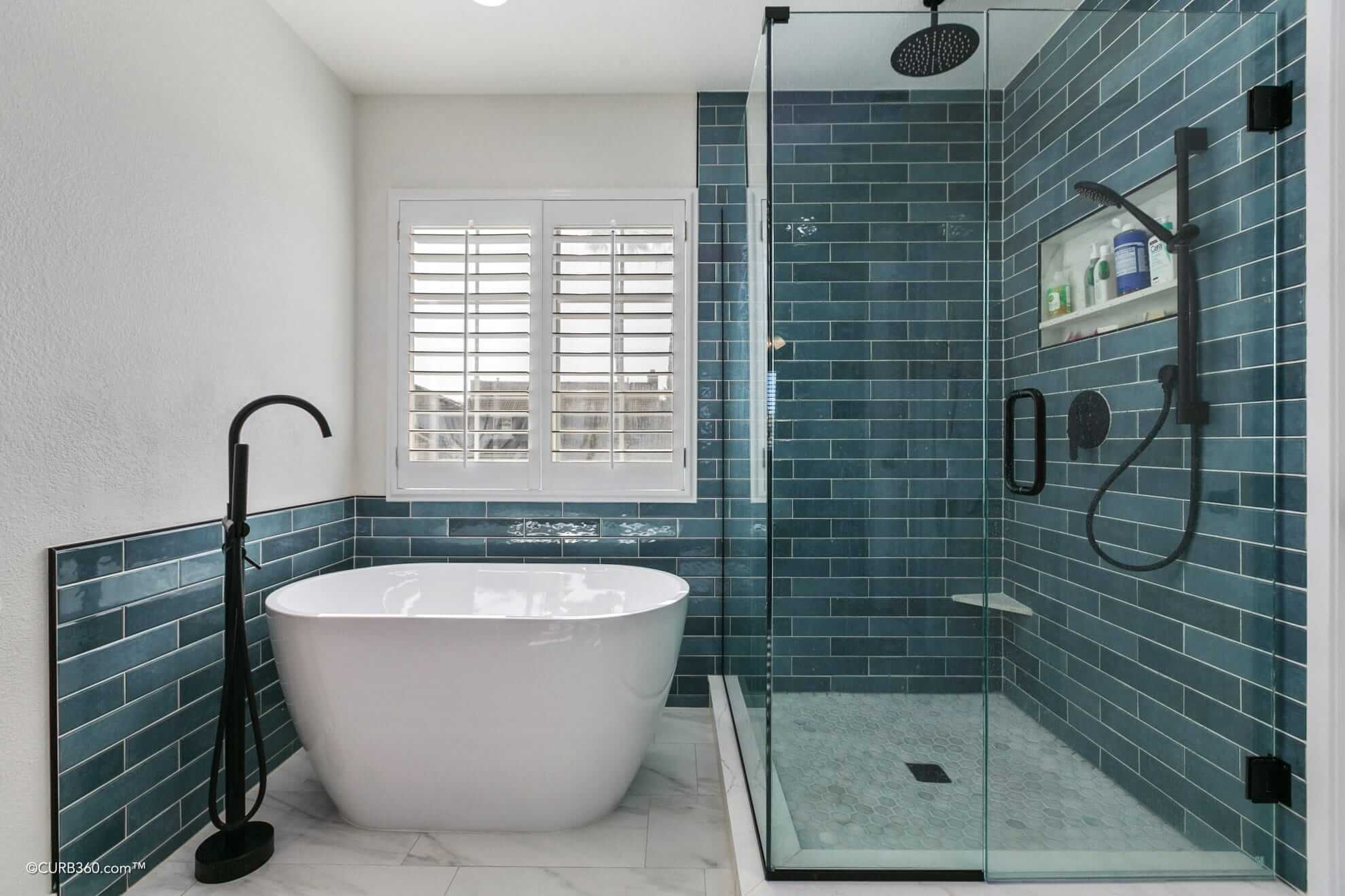 Custom bathroom remodel featuring teal tile and matte black fixtures