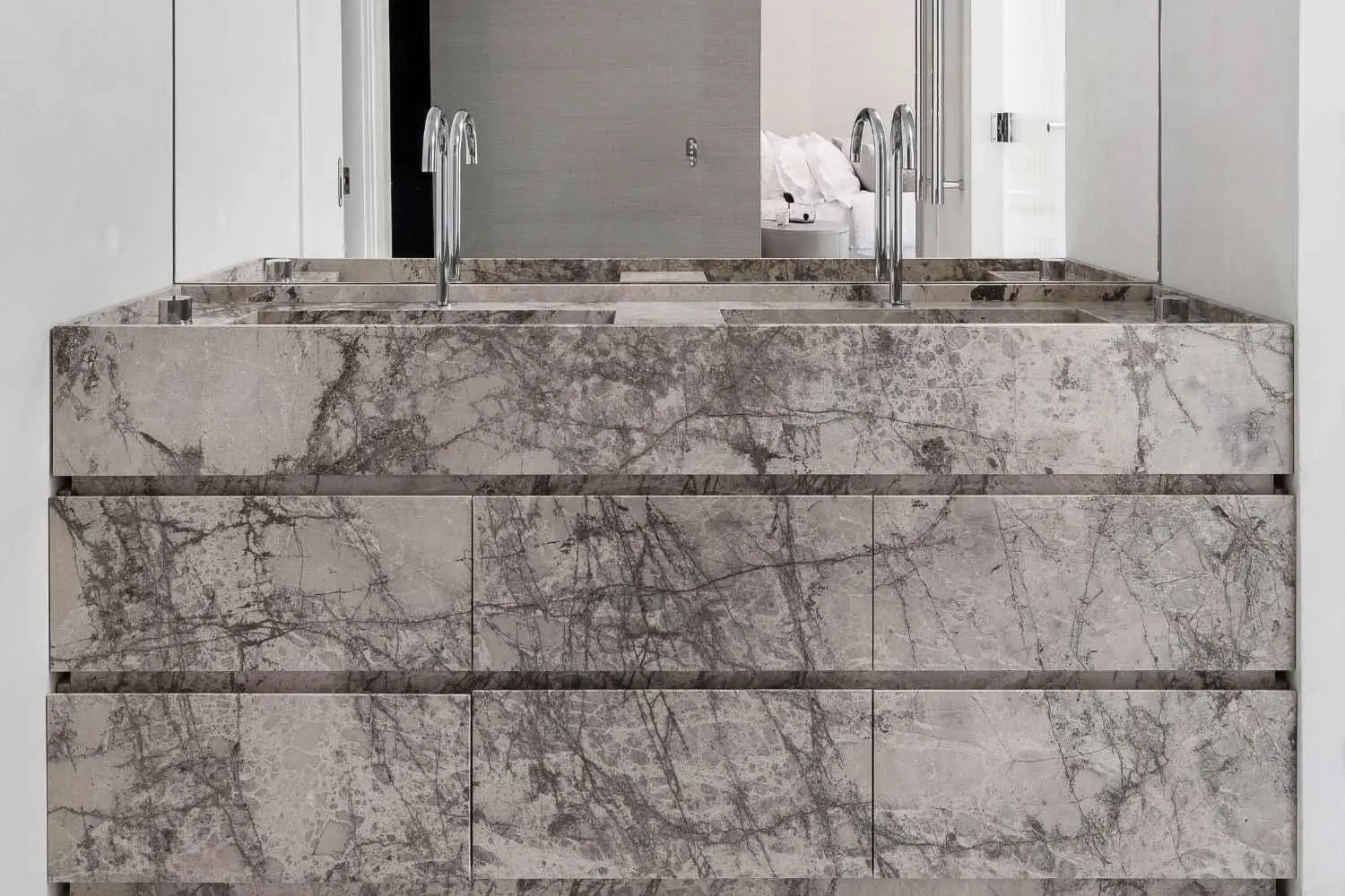 Modern marble bathroom sink with dual faucets in minimalist interior design