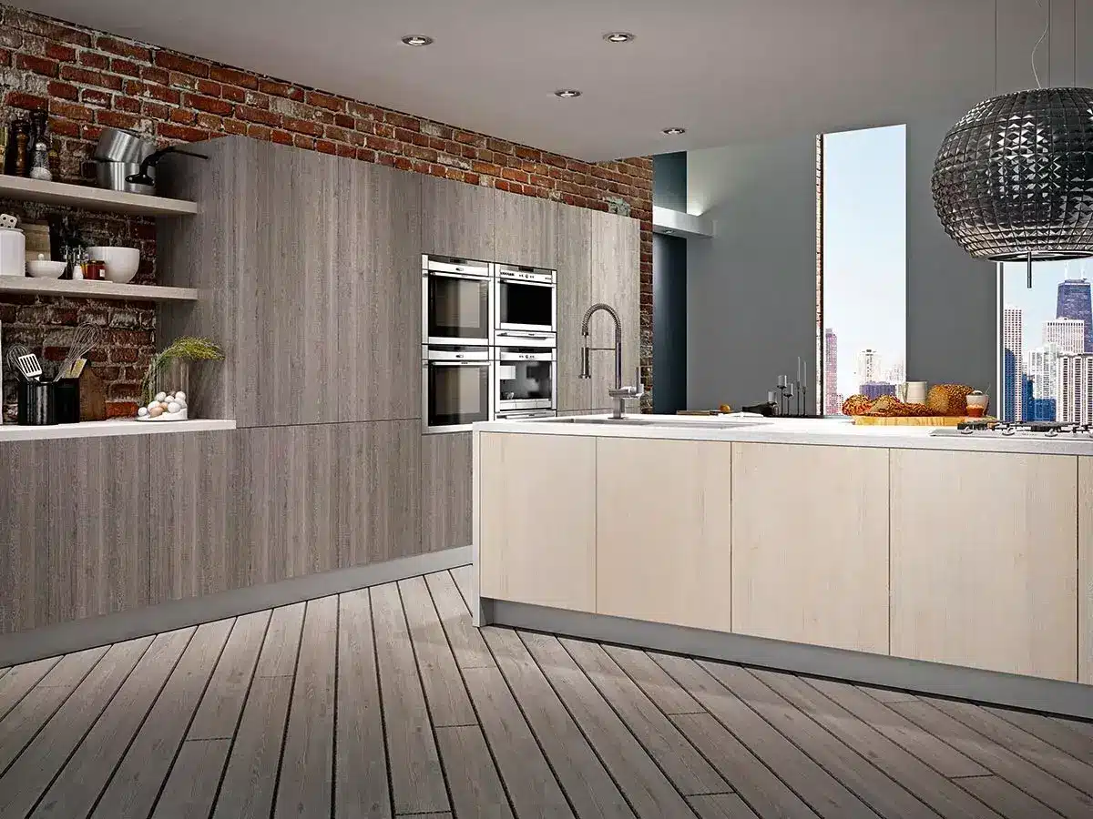 Modern open kitchen with brick walls, wooden cabinets, stainless steel appliances, and large pendant light