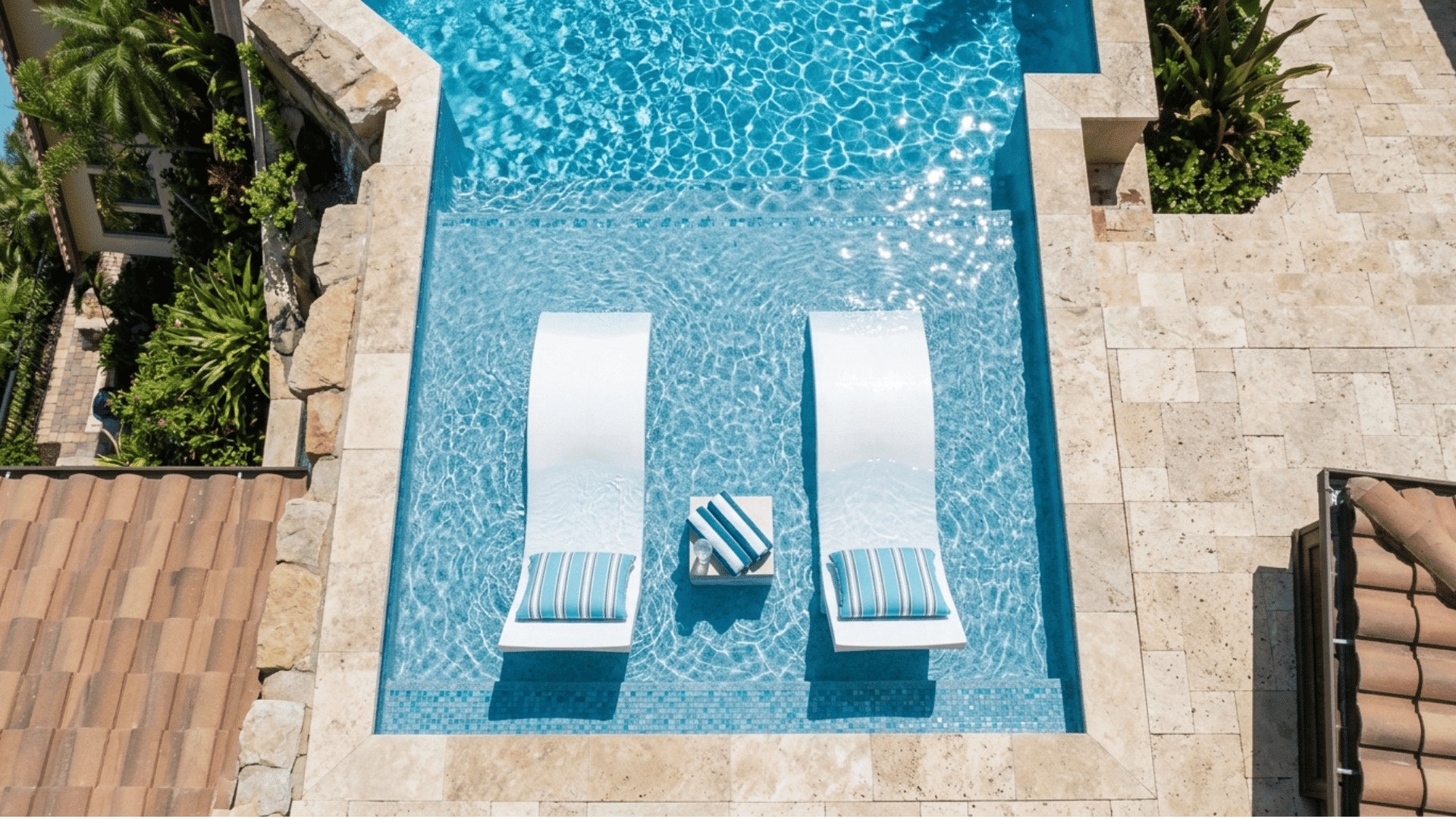 shallow tanning ledge with lounge chairs in a pool