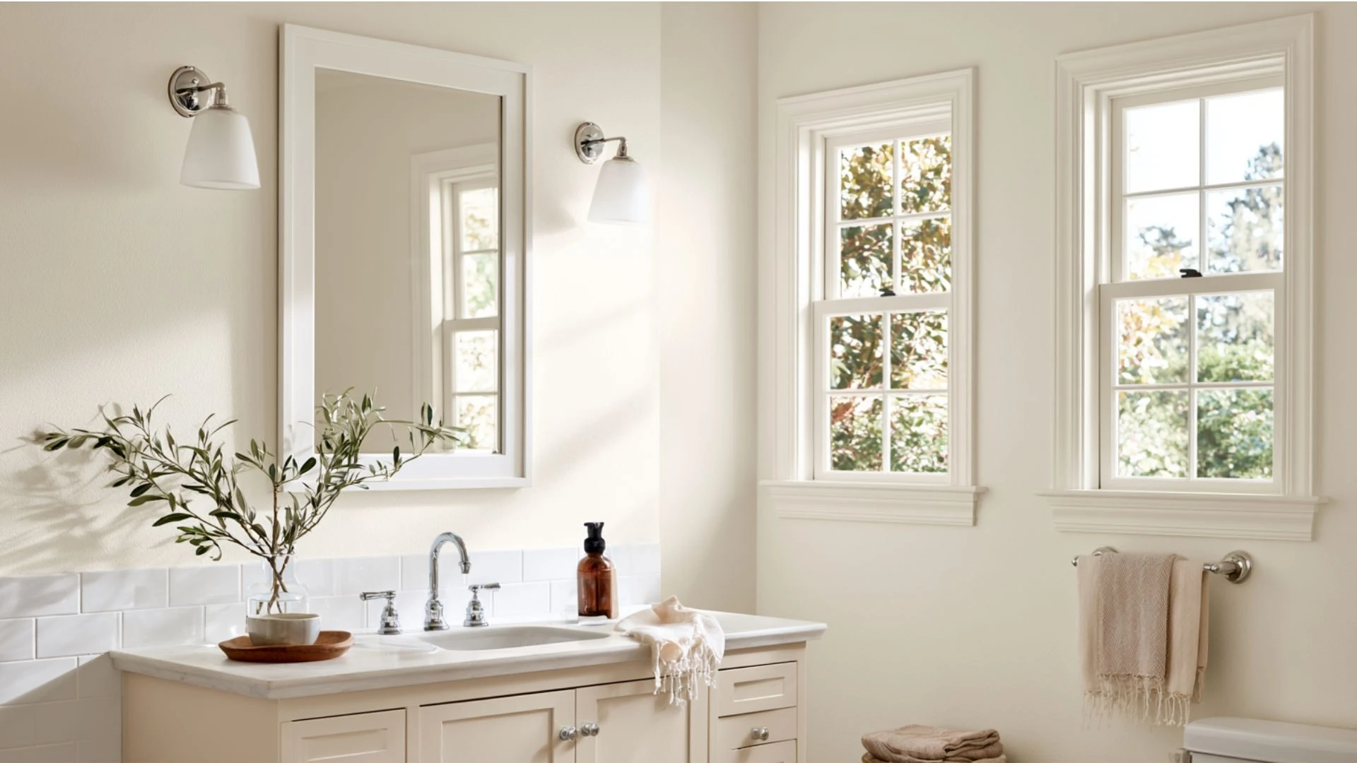 A bathroom featuring white walls and a modern sink, creating a clean and minimalist aesthetic.