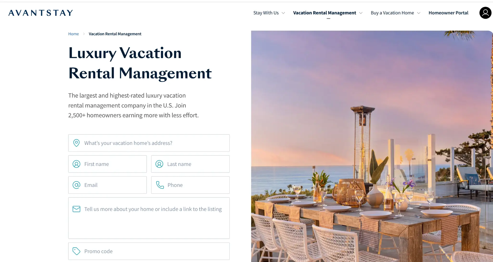 Outdoor dining table with wicker chairs and decorative items overlooking ocean at sunset