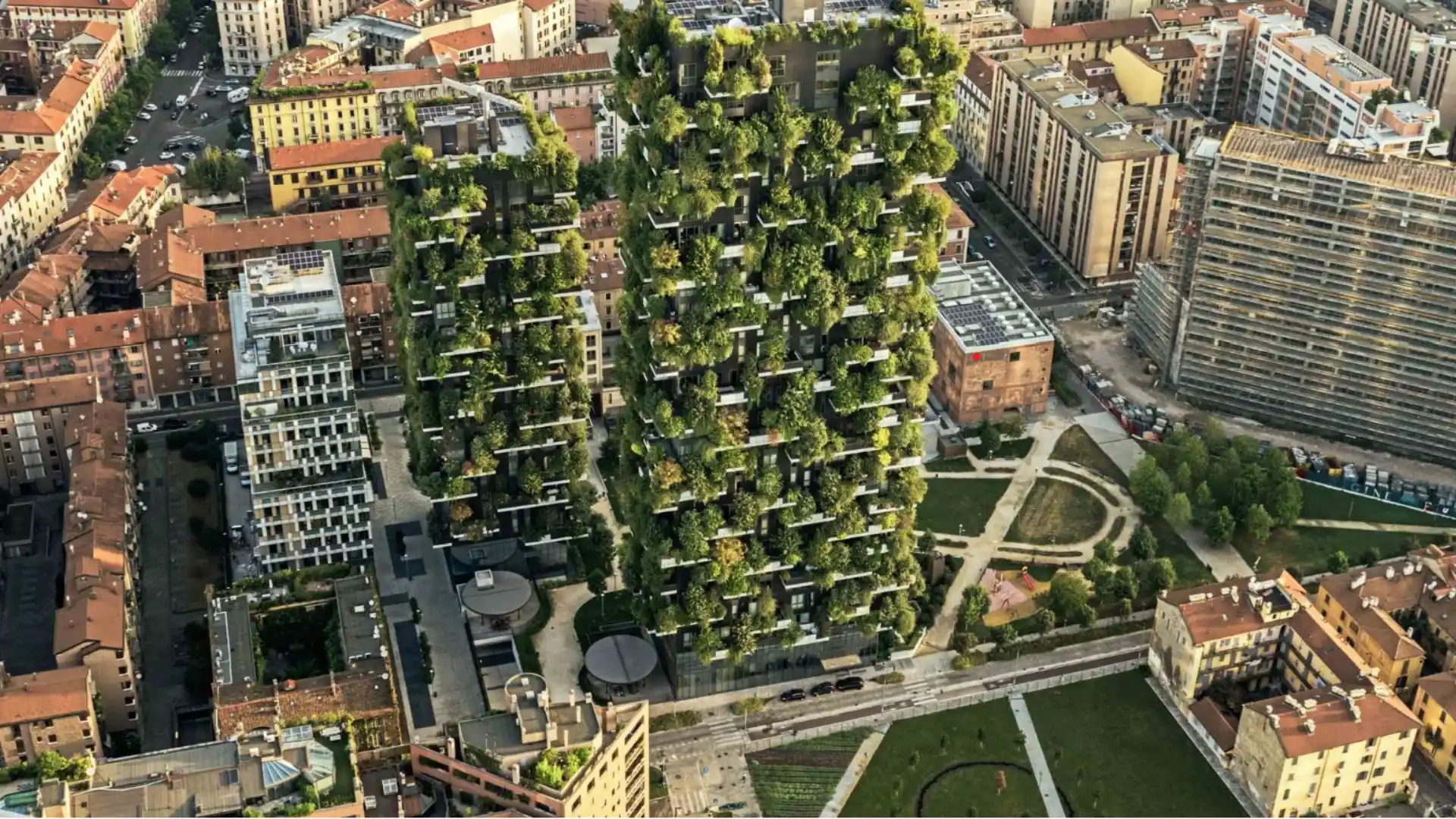 bosco verticale residential tower in milan covered with dense trees shrubs and planted balconies