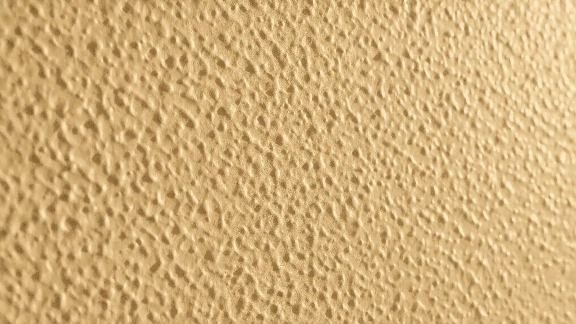 Close-up view of beige medium orange peel wall texture