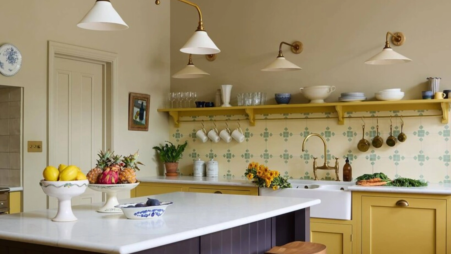 Kitchen with taupe walls, yellow cabinets, tiled backsplash, and island