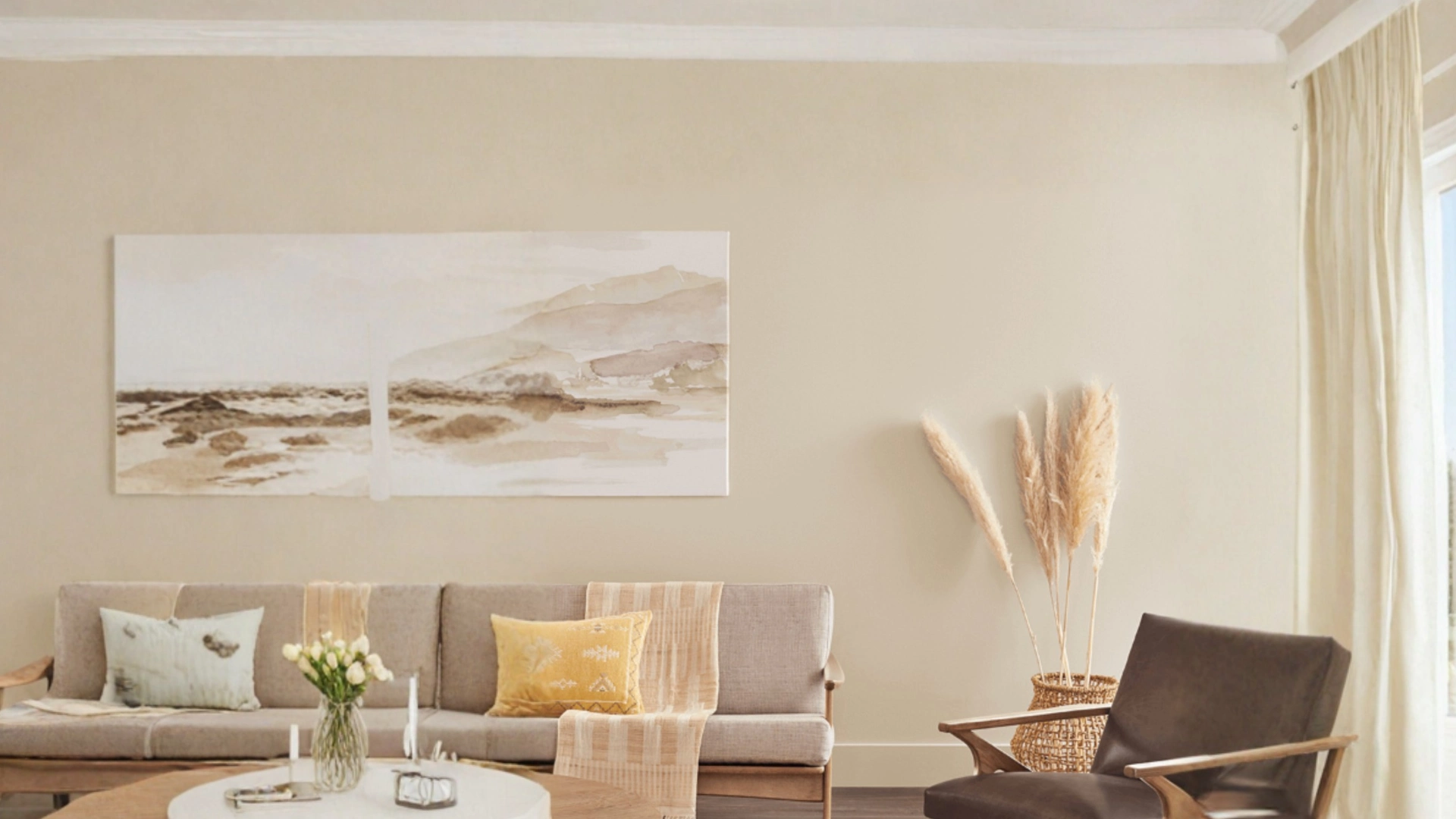 Modern living room with cool taupe painted walls, sofa, frame art, and pampas grass