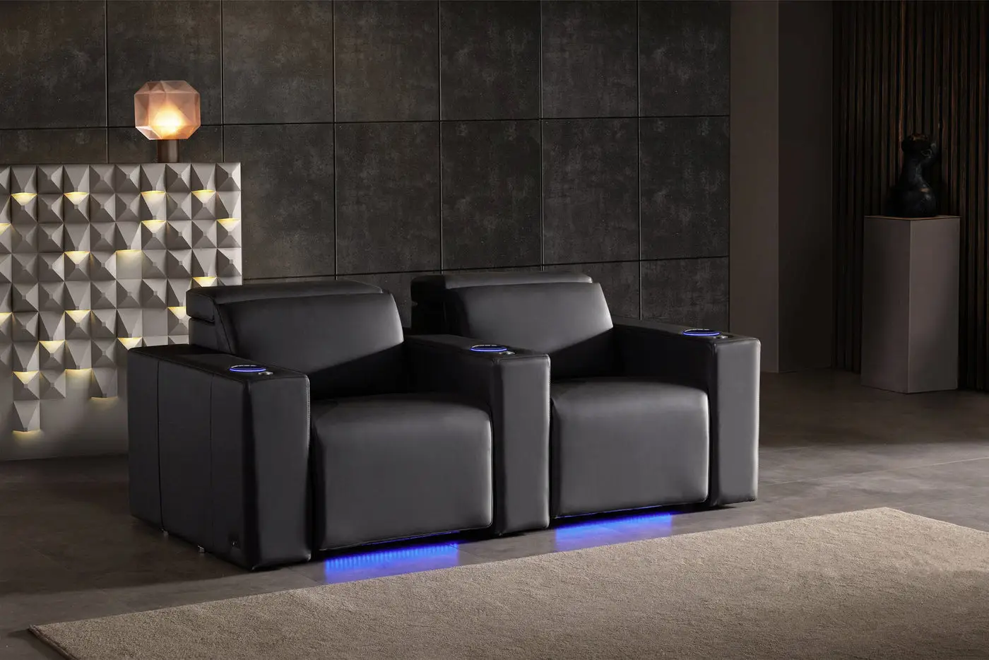 Black leather recliners with blue LED lighting in a modern home theater setting