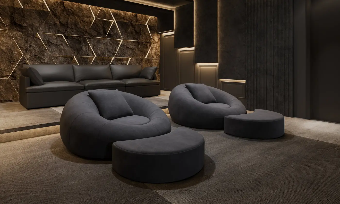 Contemporary lounge area with plush black seating and geometric stone accent wall in dim lighting
