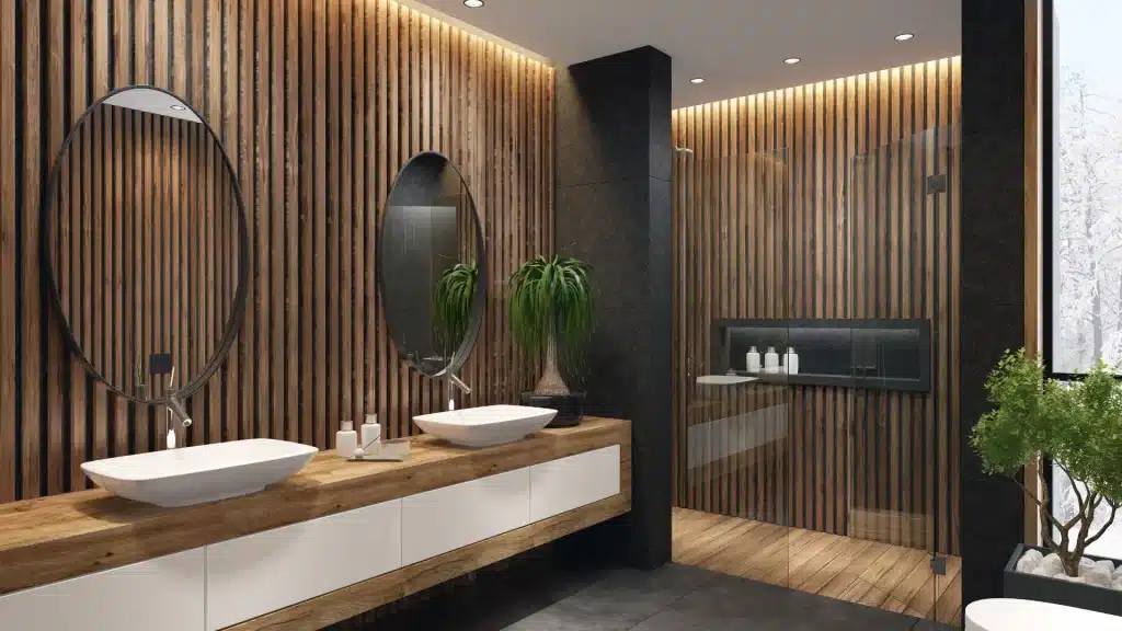 Modern bathroom with wooden wall panels, double sinks, and large mirrors with planters nearby