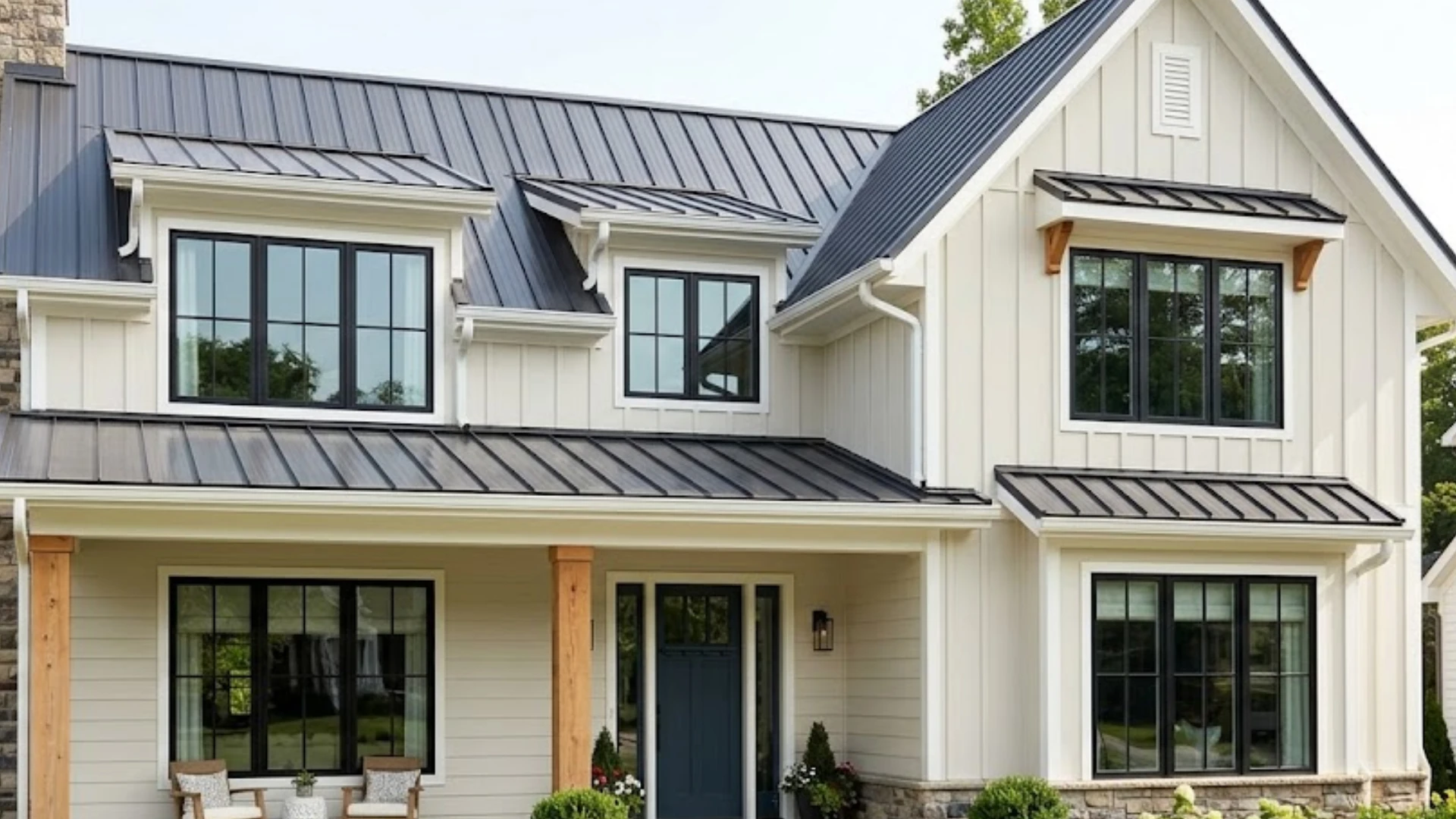 Modern two-story home with Balboa Mist exterior siding, dark metal roofing, black windows, wood posts, and stone accents.