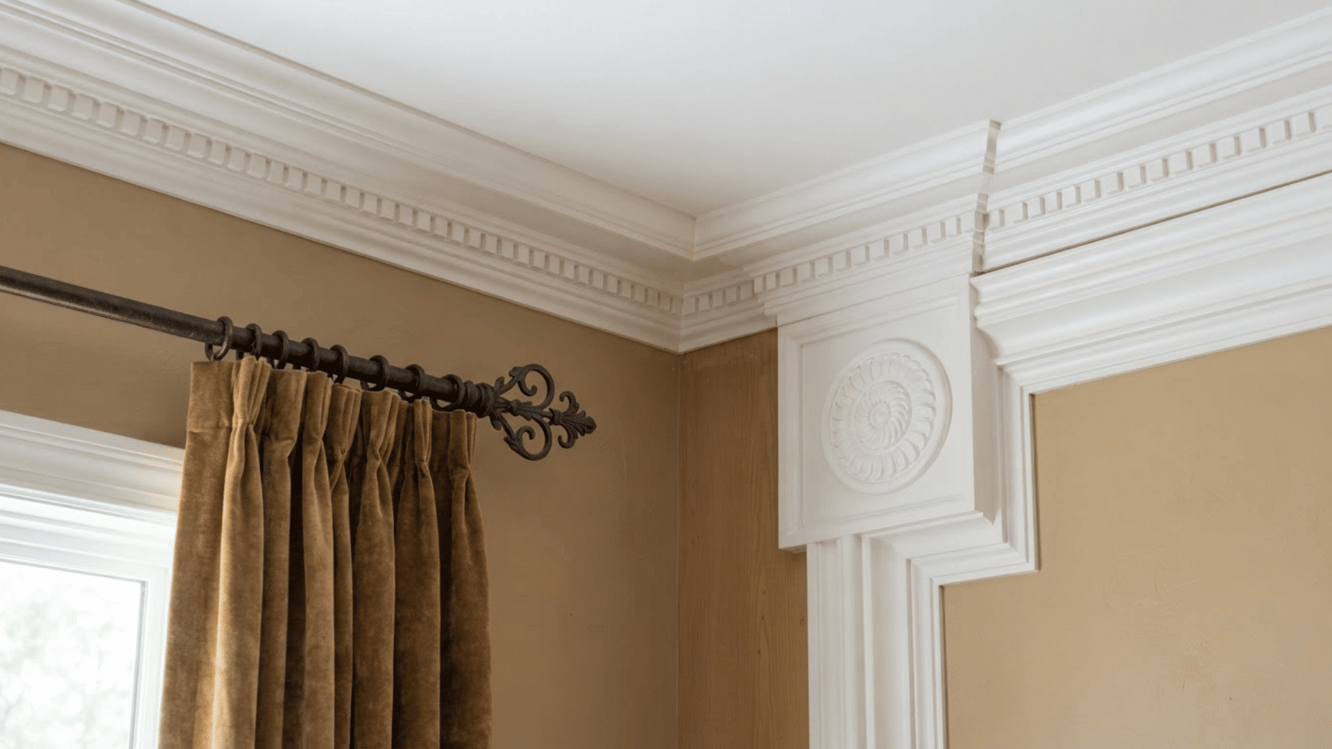 Types of crown molding shown in one interior with decorative trim around walls.