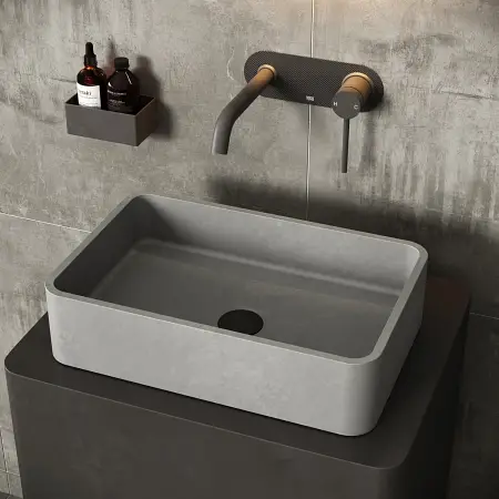 Rectangular stone sink with wall-mounted faucet in modern bathroom setting