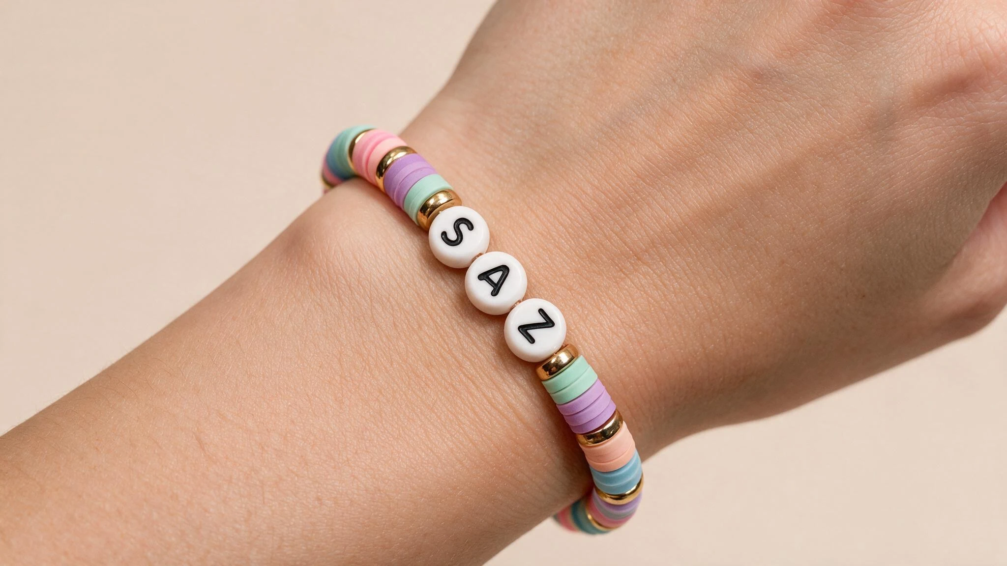 Close-up of a woman's wrist adorned with a bracelet featuring the word