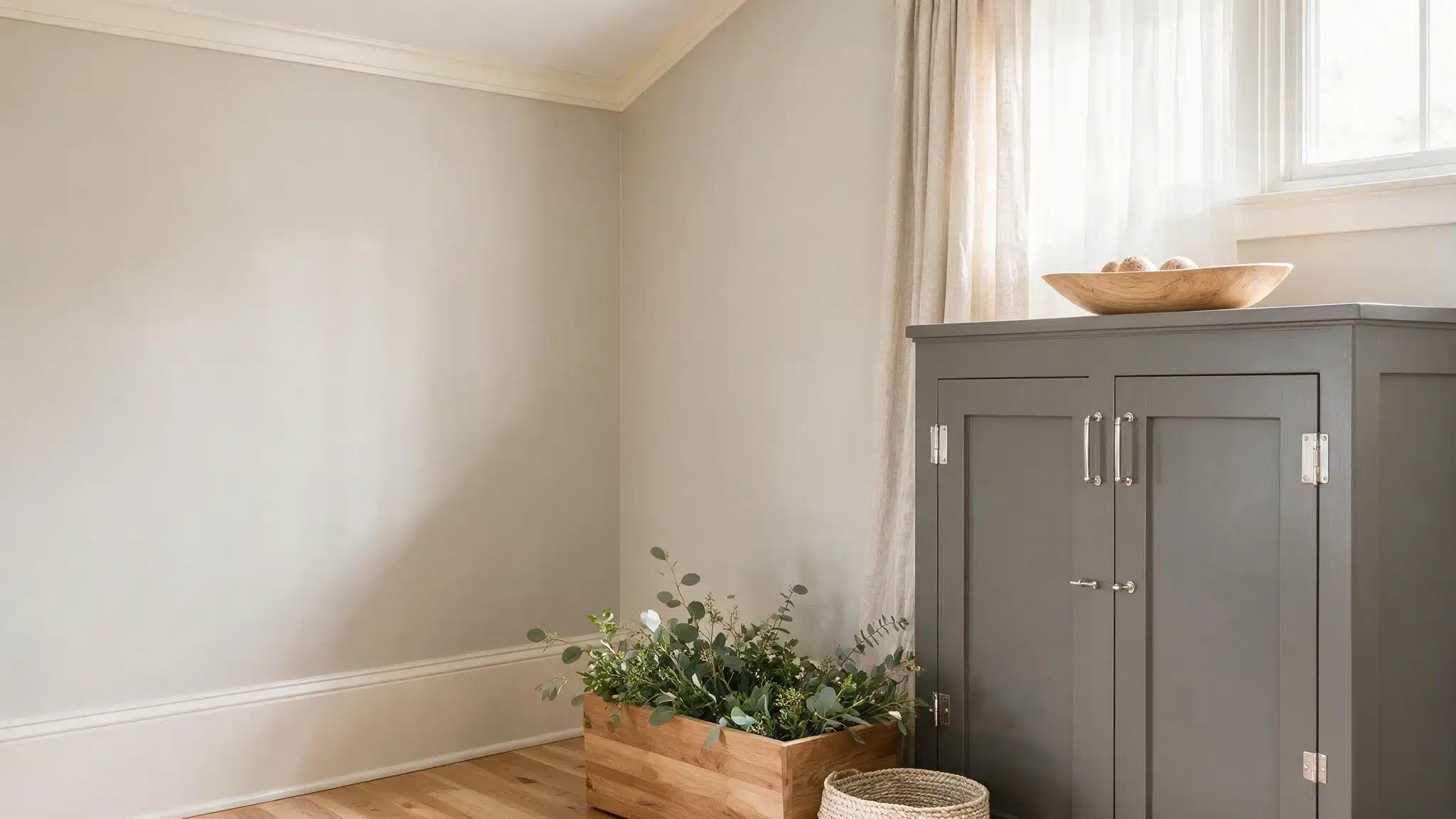 Agreeable Gray walls paired with Gauntlet Gray cabinetry warm wood flooring white trim and soft natural light