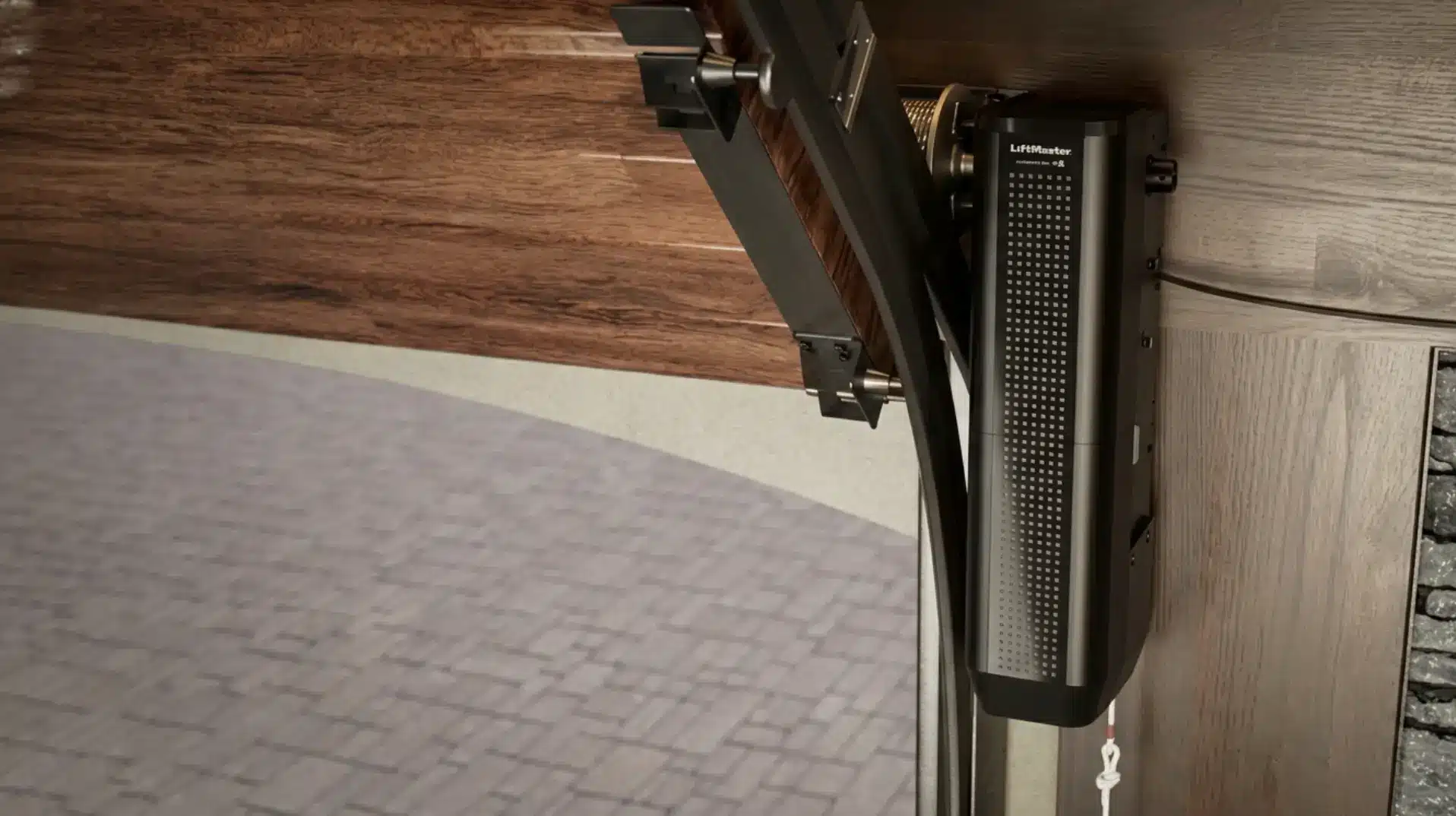 Garage door opener mechanism with wooden panel and metal hardware in an industrial setting