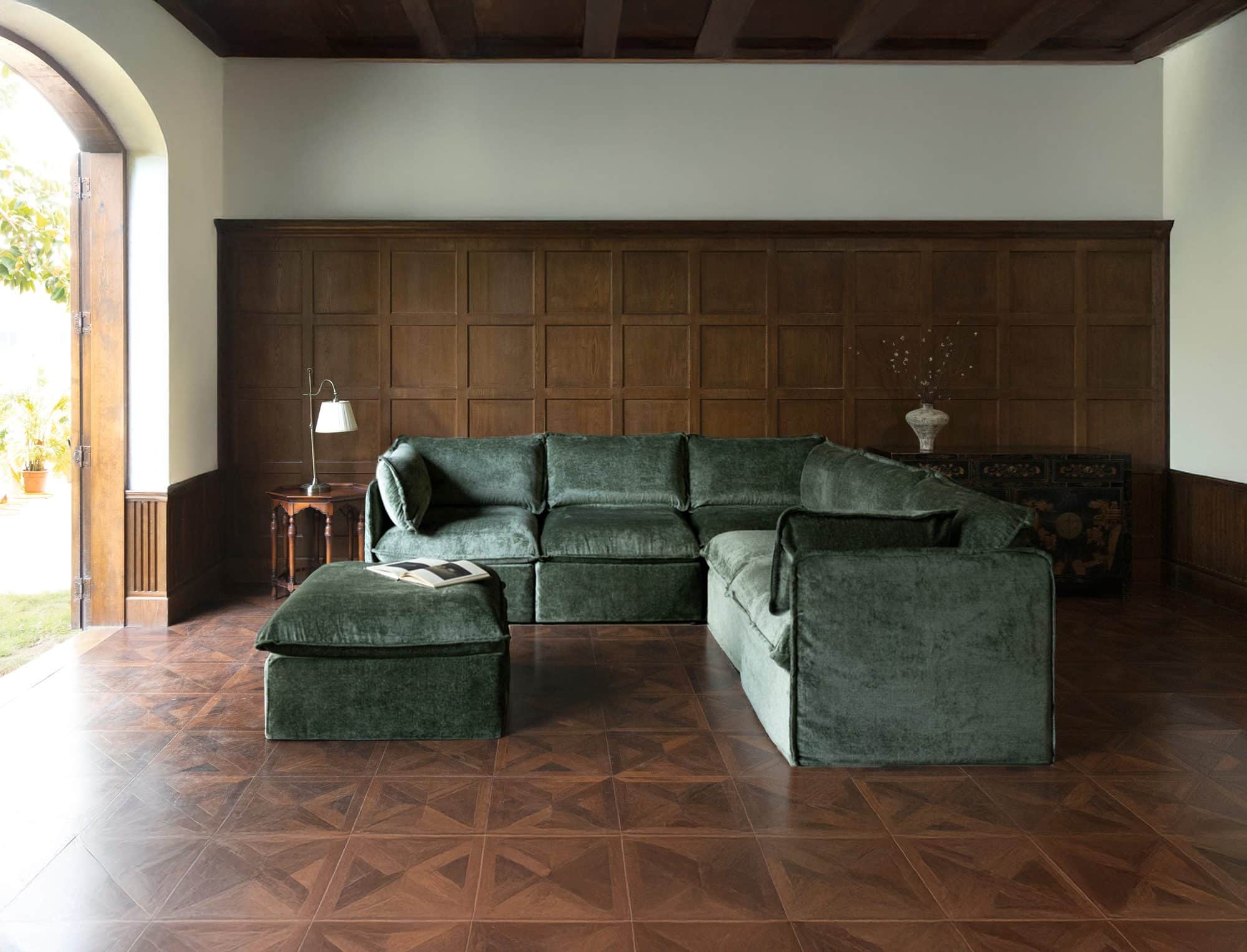 Anabei L-shaped modular sectional with ottoman in Willow green washable fabric in a wood-paneled room